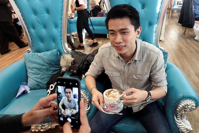 A customer poses for a photo with his Selfieccino coffee at The Tea Terrace in London.