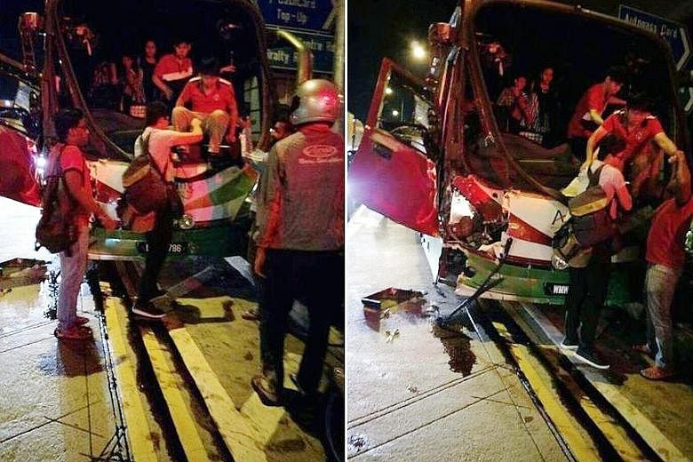 Above: Mr Shen Zhongsheng's car was crushed by two trailers after a passenger bus hit the one behind him, causing a chain collision in Woodlands Crossing yesterday morning that left 26 people injured. Below: Passengers climbing out of the bus after t
