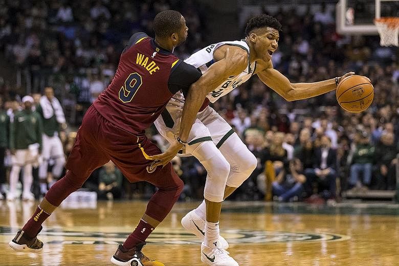 Cavaliers guard Dwyane Wade defending against Bucks forward Giannis Antetokounmpo on Tuesday. The latter led his team with 27 points as they beat the Cavs for the first time this season.