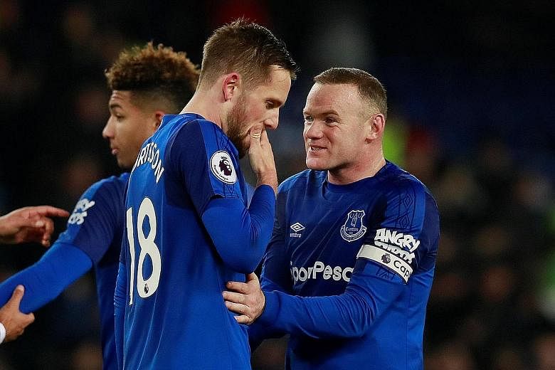 Everton's Wayne Rooney celebrating with team-mate Gylfi Sigurdsson after the latter's splendid long-range goal against Swansea on Monday.