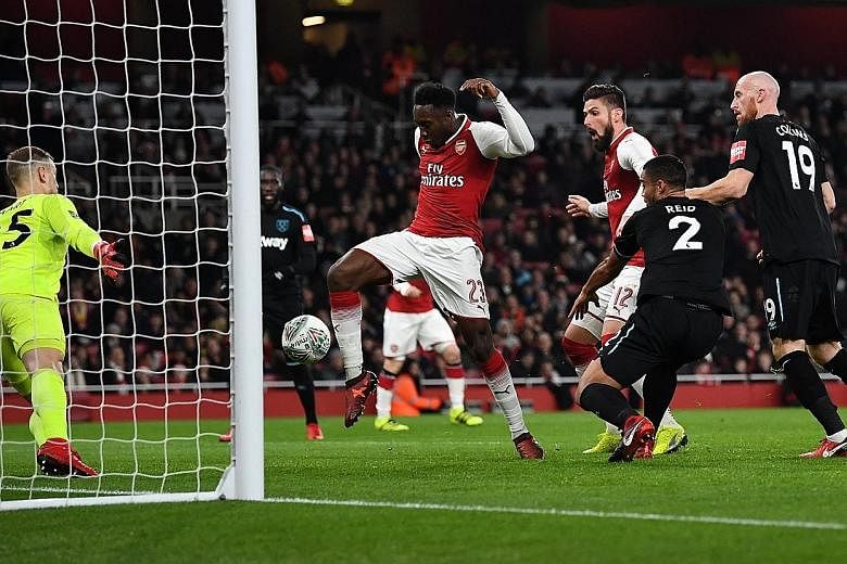 Arsenal's Danny Welbeck scoring the only goal of the game past West Ham's Joe Hart at the Emirates Stadium. Manager Arsene Wenger started with a totally changed XI but Olivier Giroud and Francis Coquelin left injured.