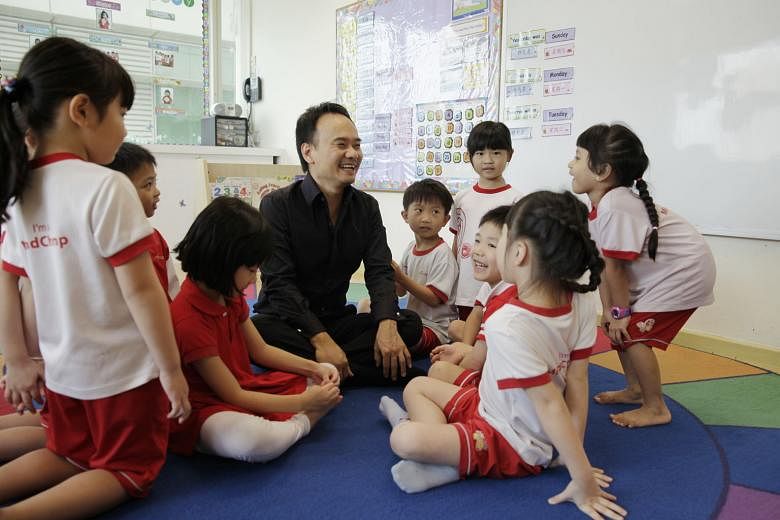 Mr David Chiem, founder of MindChamps PreSchool, with pupils in a MindChamps centre. The company has 10 company-owned and 44 franchisee-operated pre-schools and reading-and-writing centres across Singapore, Australia, the Philippines and the United A