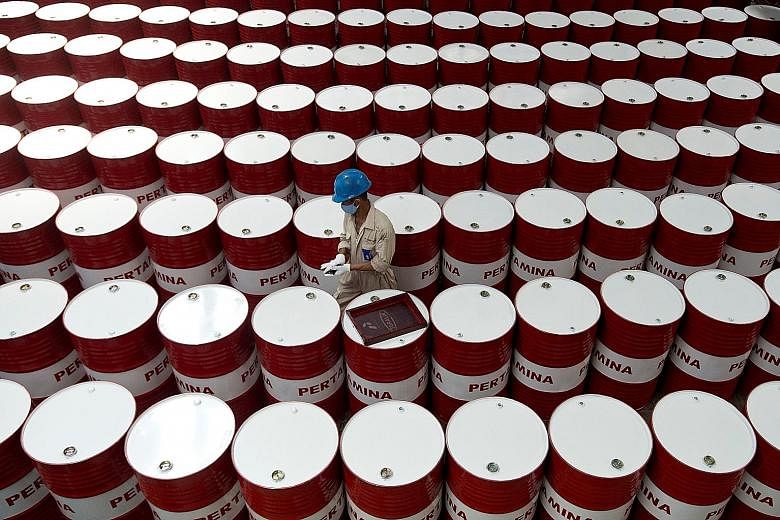 Barrels of lubricant oil at state oil firm Pertamina's facility in Central Java. Fitch expects Indonesia's GDP to rise 5.4 per cent next year and 5.5 per cent in 2019, from 5.1 per cent this year.