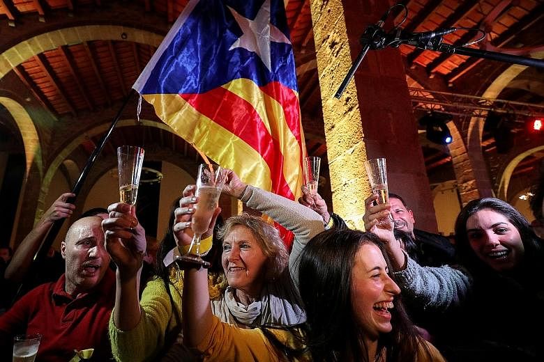 People at a gathering organised by the Catalan National Assembly, an organisation that supports independence for Catalonia, reacting to the results of the regional election, in Barcelona, on Thursday. The election outcome could allow separatists to r
