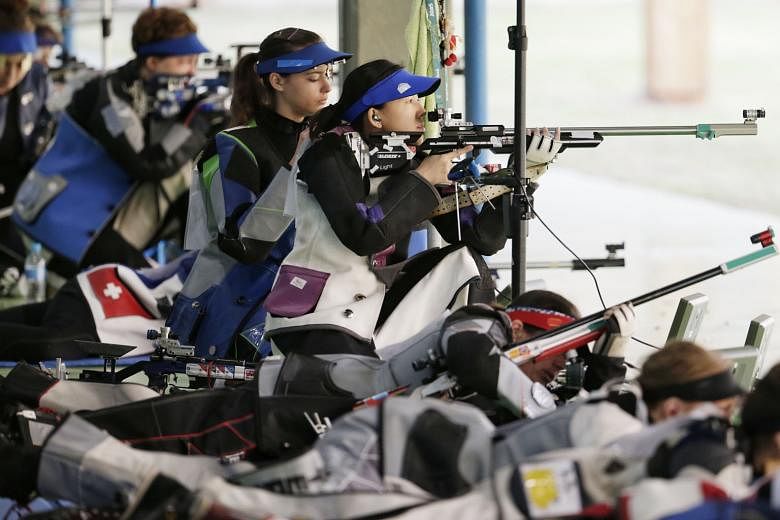 Singapore's Jasmine Ser kneeling while others are in prone position during the Rio Olympics women's 50m rifle three-positions qualification round. They will get 40 shots in each position next year, double the current 20.