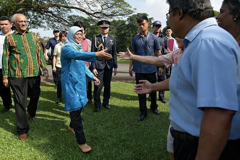 President Halimah Yacob greeting visitors at the Istana. Since taking office, one of her initiatives has been to make the Istana more accessible.