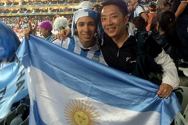 IT professional Justin Foo (left) at the 2014 World Cup semi-final between the Netherlands and Argentina. The 41-year-old will buy tickets from online reseller Viagogo, which is frowned upon by Fifa, if he cannot get them through official channels. M