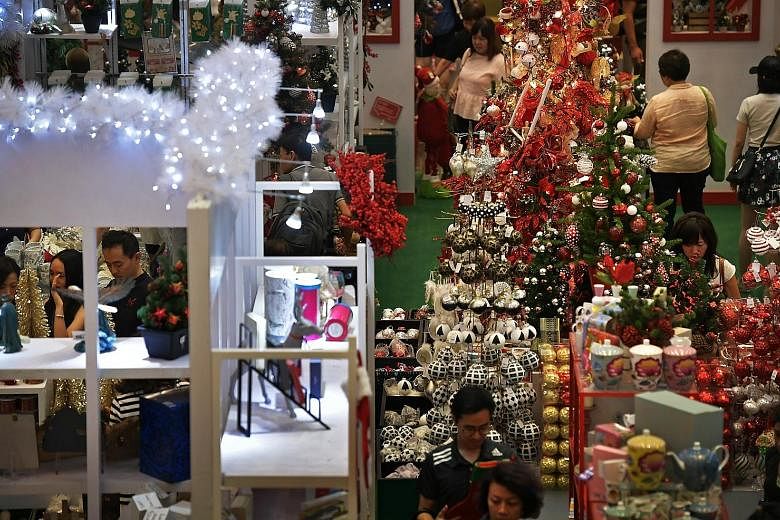 Customers in Paragon mall doing their last-minute Christmas shopping yesterday. The reported surge in spending seen by retailers coincides with a new survey which showed that consumer confidence in Singapore went up in the third quarter of this year 