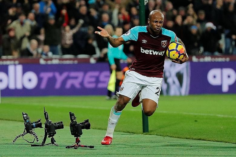 Left: West Ham's Andre Ayew celebrates his strike in the 69th minute, but it did not atone for his awful 56th-minute penalty miss on Saturday. Right: Ayew's brother, Jordan, also got into the scoring act with a late leveller for Swansea against Cryst