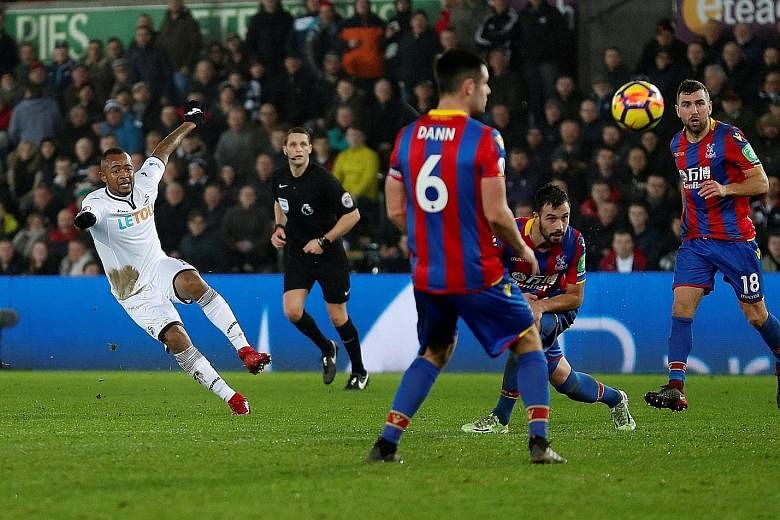 Left: West Ham's Andre Ayew celebrates his strike in the 69th minute, but it did not atone for his awful 56th-minute penalty miss on Saturday. Right: Ayew's brother, Jordan, also got into the scoring act with a late leveller for Swansea against Cryst