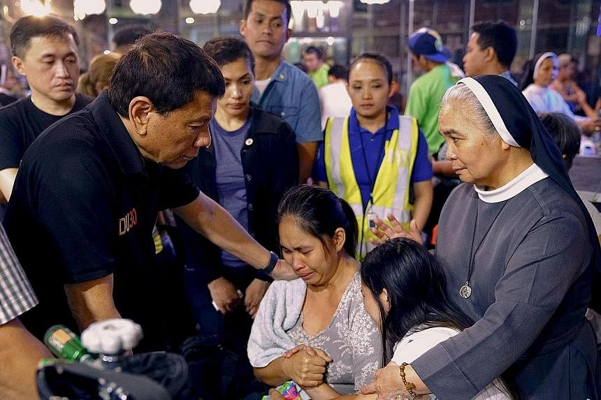 The blaze at the four-storey NCCC Mall in Davao, southern Philippines, was brought under control early yesterday but fire officials said they had yet to enter the section where the missing were believed to be trapped. Philippine President Rodrigo Dut