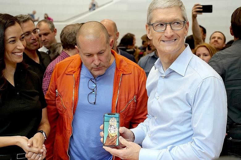Apple's CEO Tim Cook (right) and design chief Jony Ive with the iPhone X at a US media event in September.