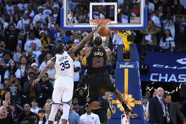 Golden State Warriors' Kevin Durant blocking LeBron James of the Cleveland Cavaliers with 24.5sec to go as they held on to win 99-92 on Monday in Oakland. The Cavs forward took umbrage with the officials' call, believing he was fouled, with the ball 