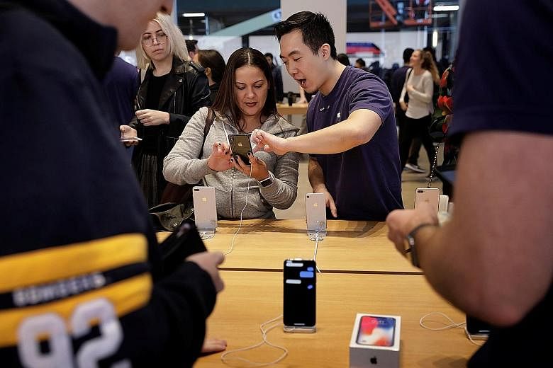 A customer at an Apple store in New York. The lawsuits seek class-action to represent potentially millions of iPhone owners across the US.