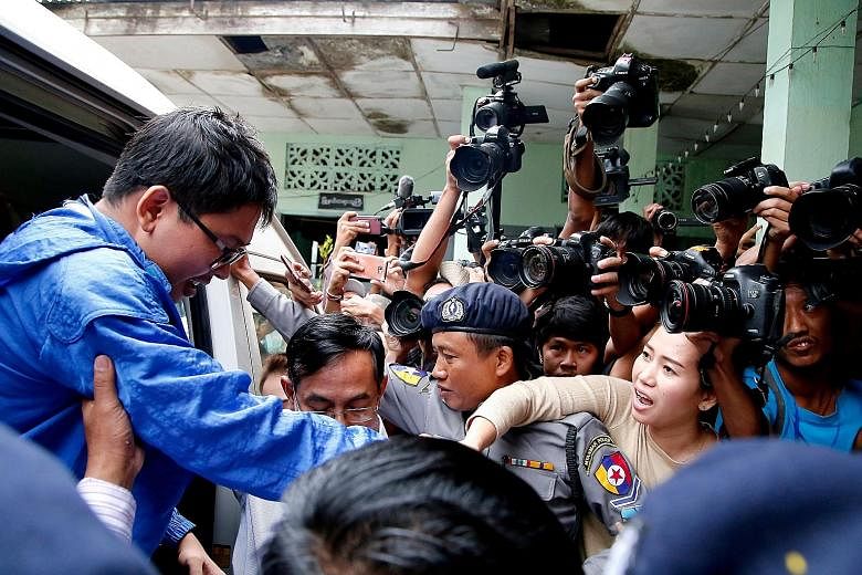 Reuters reporter Wa Lone (left) stepping out of the van that took him to court yesterday, as his wife, Ms Pan Ei Mon, tries to hold his hand. Mr Kyaw Soe Oo (above) is the other journalist in custody. Both are being investigated for breaching Myanmar