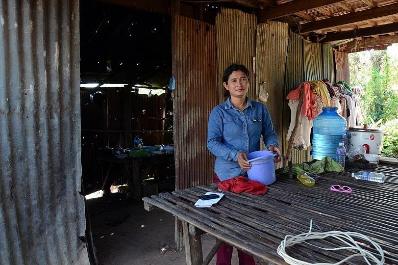 Ms Ren Ruon, 40, a villager in Kampong Cham province, uses a microloan to finance her small business selling fruit to factory workers. However, she admits she loses sleep sometimes thinking about the land that she could lose as collateral if she ever