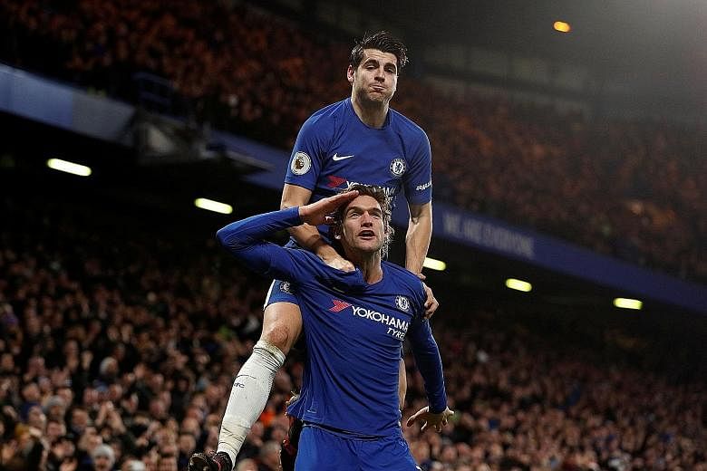 Chelsea wing-back Marcos Alonso saluting the Stamford Bridge crowd after scoring the second goal in the 2-0 win over Brighton on Tuesday as striker Alvaro Morata, scorer of the first goal, joins in the celebration.