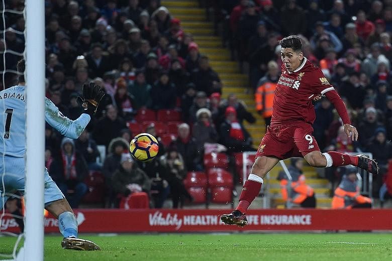 Liverpool's Brazilian midfielder Roberto Firmino volleying the ball from a Philippe Coutinho cross to score their second goal against Swansea at Anfield on Tuesday. They ran out 5-0 winners against the bottom side.