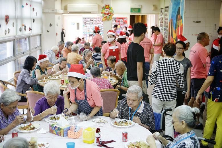 Mr Anson Ng, a 50-year-old car dealer, serving the food he prepared with the help of volunteers to Mr Yip Heng Tuck, a 54-year-old terminally ill patient at the Dover Park Hospice, last Friday. "I find it meaningful to help make each meal good in cas