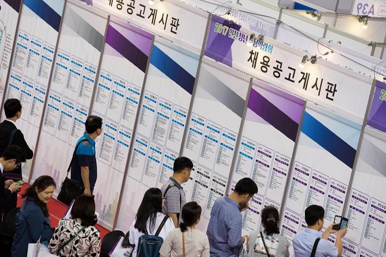 Job seekers checking out listings at a job fair in Incheon, South Korea, in May. The government expects shrinking of the working-age population to accelerate next year at a much faster rate than those of Japan and the US.