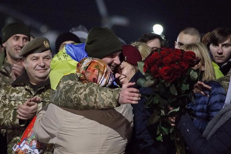 Relatives and friends welcoming a released Ukrainian hostage after the prisoner exchange at Kharkiv airport near Horlivka city in Ukraine on Wednesday.