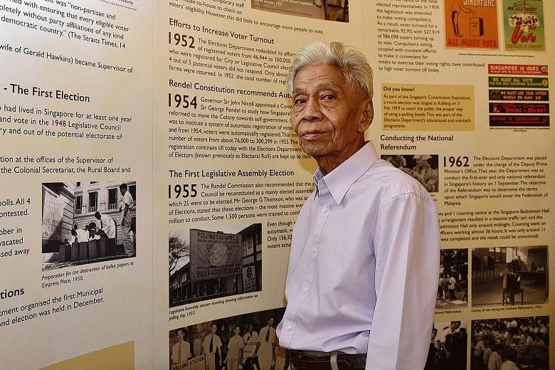 Mr Puteh Mahamood, who has worked at the Elections Department since it was formed 70 years ago, beside an exhibition panel showing the department's key milestones at the Fullerton Hotel yesterday.