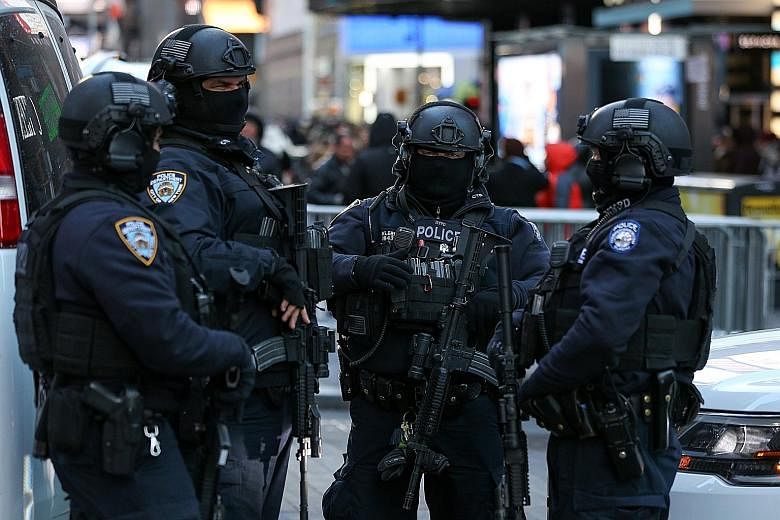 New York Police Department Counterterrorism Bureau members at Times Square on Thursday as part of beefed-up security ahead of New Year's Eve celebrations in Manhattan. Heavy-weapons teams and dog patrols will also be deployed throughout the area.