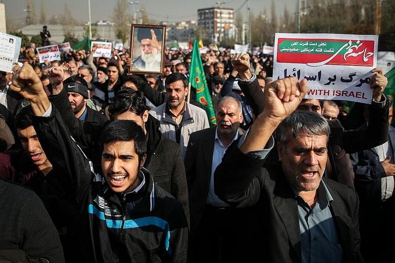 People chanting slogans in the Iranian capital Teheran as they marched in support of the government yesterday. The pro-government rallies have been held annually to mark the end of months of street protests, which followed former president Mahmoud Ah