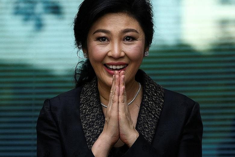 Above: A photo purportedly showing ousted former Thai prime minister Yingluck Shinawatra shopping in London. Left: Yingluck greeting supporters in Bangkok in August.