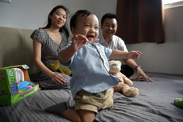 Straits Times correspondent Amelia Teng, 29, with her one-year-old son Christopher and husband, Geoffrey Toi, 33. The cheapest option of the lifelong medication needed for Christopher costs $5,000 a month and the drug has to be procured from Australi
