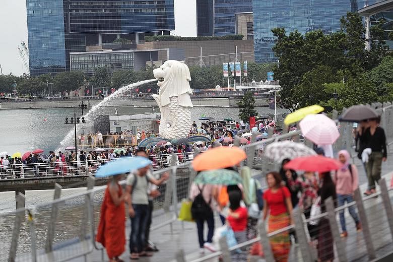 Many revellers came equipped with umbrellas and ponchos yesterday as they did not want to miss the fireworks and the light-up of buildings in the area.