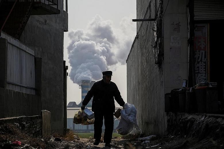 Smoke billowing from the chimney of a factory in rural Gaoyi county, known for its ceramics production, near Shijiazhuang, Hebei province. A punishing crackdown on air pollution and a cooling property market have begun to weigh on the world's second-