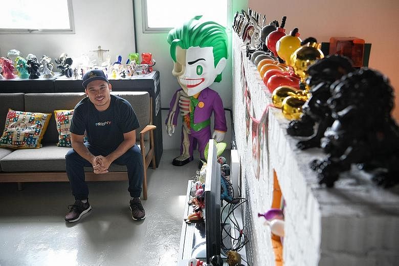 Mr Jackson Aw, 28, founder of local designer toy company Mighty Jaxx, at his office in Prosper House, Geylang, next to an XXRAY figure of the Joker. The company, which now works with brands like Warner Bros and is projected to hit $5 million in reven
