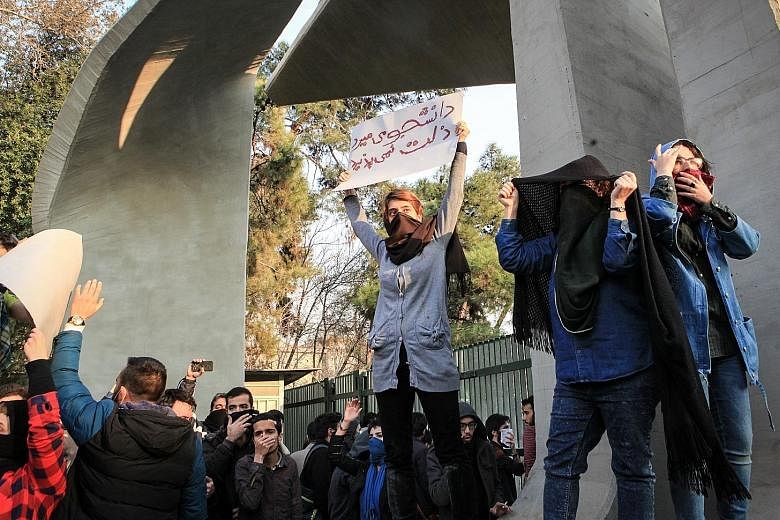 Iranian students protesting against the government near the University of Teheran.