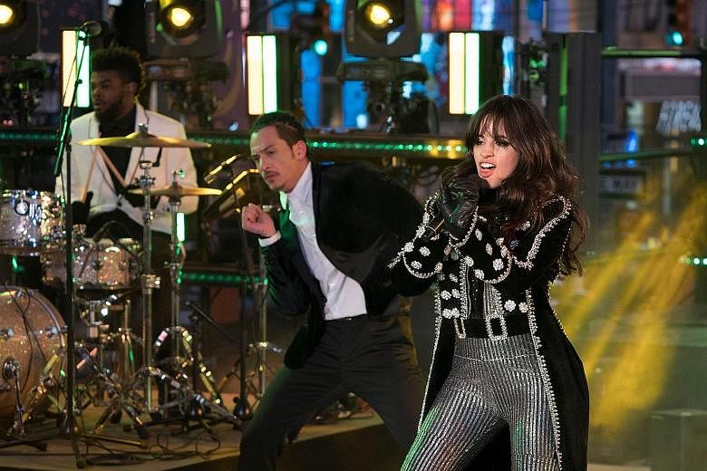 (Clockwise from left) Singers Mariah Carey, Camila Cabello and Nick Jonas performing during the New Year's Eve celebrations in Times Square in New York City.