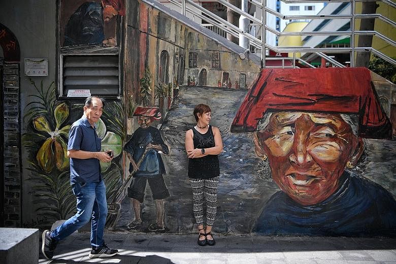 Ms Belinda Low, pictured here with one of her mural paintings of samsui women in Kreta Ayer, paints Singapore scenes on public walls. She has painted some 40 murals, many of which are in prominent areas and heritage spaces such as Chinatown, Clarke Q
