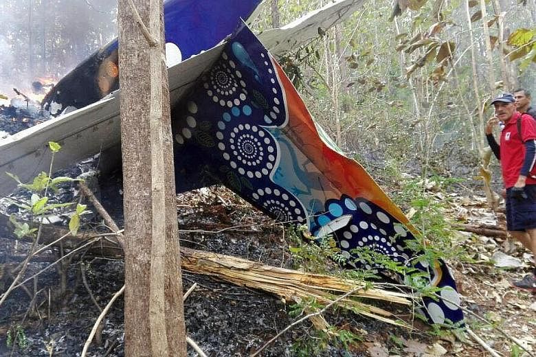 The remains of the small plane that crashed in the province of Guanacaste, Costa Rica, on Sunday. The crash killed all 10 American tourists on board and two local crew members. Strong winds may have been a factor, say officials and witnesses.