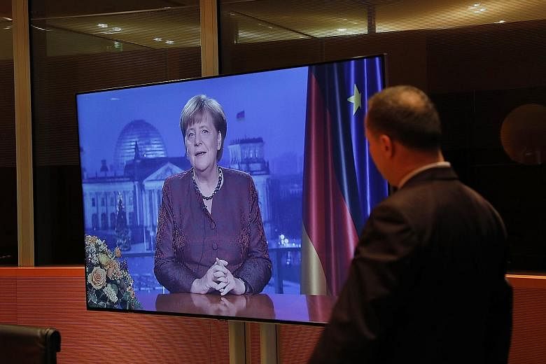 German Chancellor Angela Merkel recording her annual New Year's address in Berlin. There are mounting questions about whether her party and the SPD can agree to renew their "grand coalition".