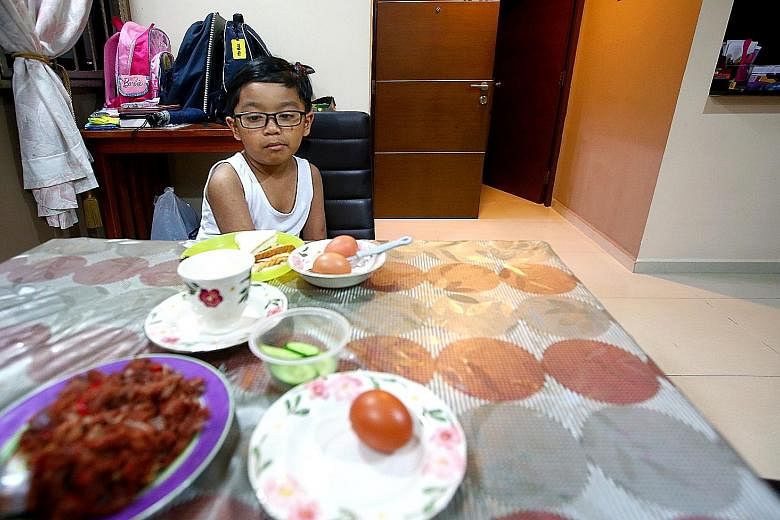 From left: Muhammad Aiman Aqmal Nor Md having breakfast before his first day at Shuqun Primary School, and then stopping for a photo with his neighbour Grace Tng. Right: Grace, too, is all set to head to school for her first day. Form teacher Lily Ye