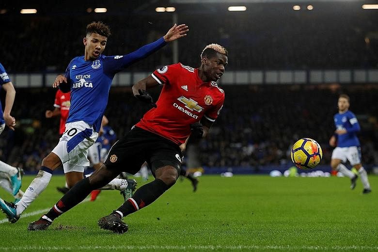 Manchester United midfielder Paul Pogba escaping the attention of Everton centre-back Mason Holgate. The France international was instrumental in the 2-0 away win on Monday.