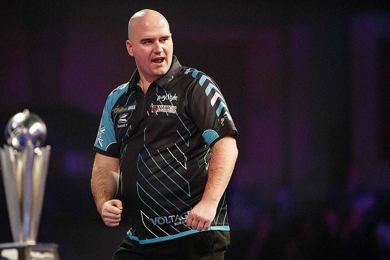 Rookie darts pro Rob Cross (left) shocked the retiring Phil Taylor 7-2 to win the world title.