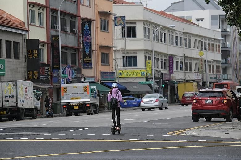 Personal mobility device users were seen travelling alongside cars, vans and pickups in Geylang yesterday at around noon. Within an hour, The Straits Times team spotted six riders along Geylang Road and Sims Avenue. One rider even zipped across the f