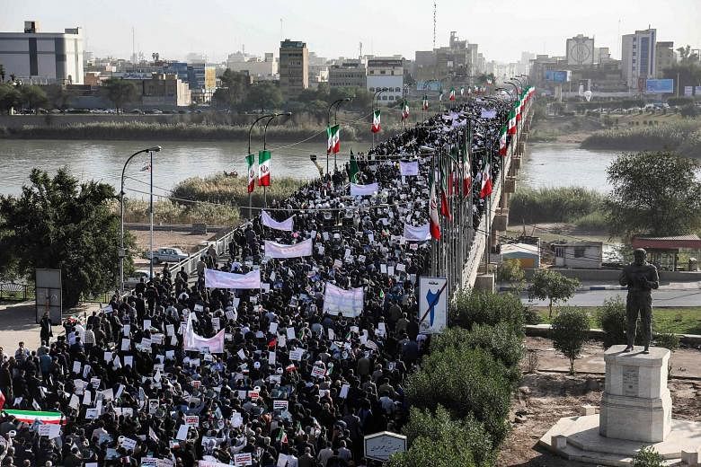 Pro-government demonstrators taking to the streets of the south-western Iranian city of Ahvaz yesterday.