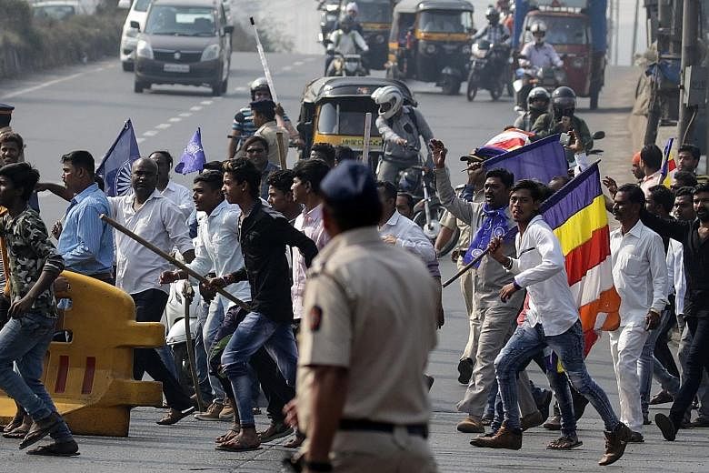 Dalits blocking the Western Express Highway in Mumbai yesterday. Protesters blocked the major roads, damaged buses and private vehicles and forced shops to close down in several parts of the city following the death of a Dalit man in the city of Pune