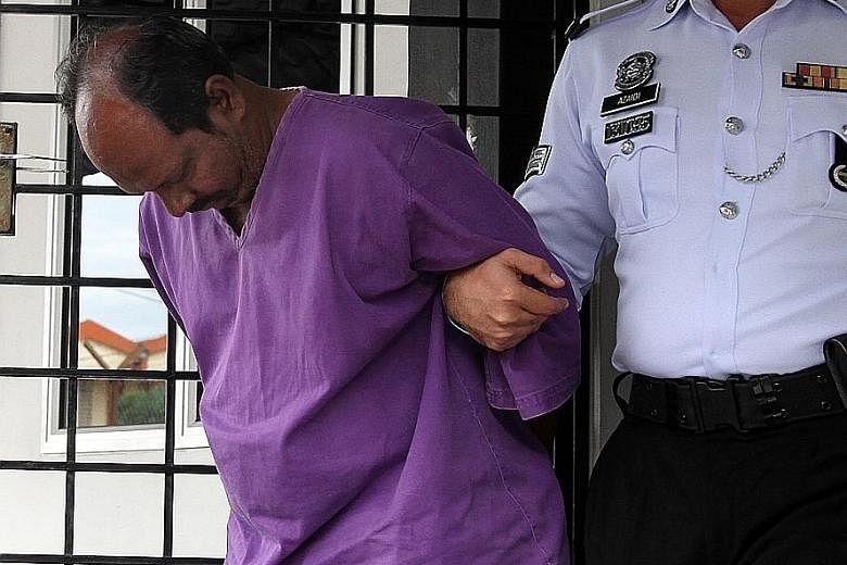 The 54-year-old suspect being led away after police obtained a four-day remand order yesterday.