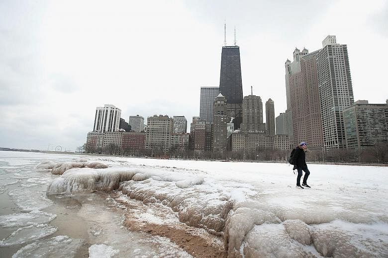 Ice building up along the shore of Lake Michigan in Chicago on Wednesday. Record cold temperatures have gripped much of the US and been blamed for several deaths over the past week.
