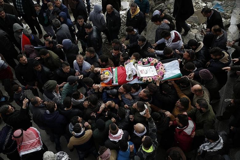 Mourners in the village of Deir Nizam, north of Ramallah in the occupied West Bank, at the funeral of 17-year-old Palestinian Musab Firas al-Tamimi yesterday. The teenager was killed during clashes with the Israeli army a day earlier.