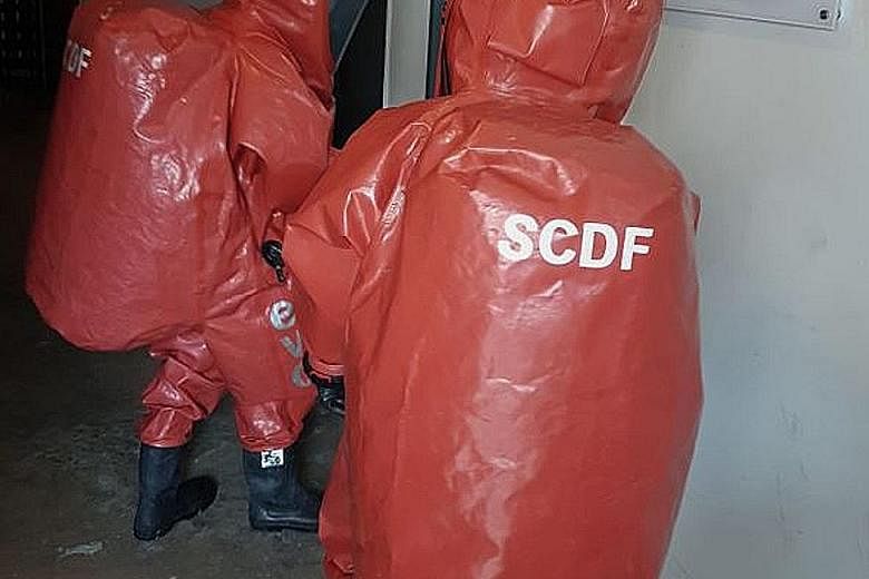 SCDF HazMat specialists (above) during the CNB raid on Dec 6 that led to synthetic cannabis (left) being seized.