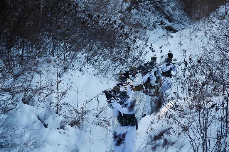 South Korean and US Marines taking part in a winter military drill in Pyeongchang, South Korea, last month. The two countries have agreed to delay the giant Foal Eagle and Key Resolve joint military drills until after the Winter Olympics, which begin