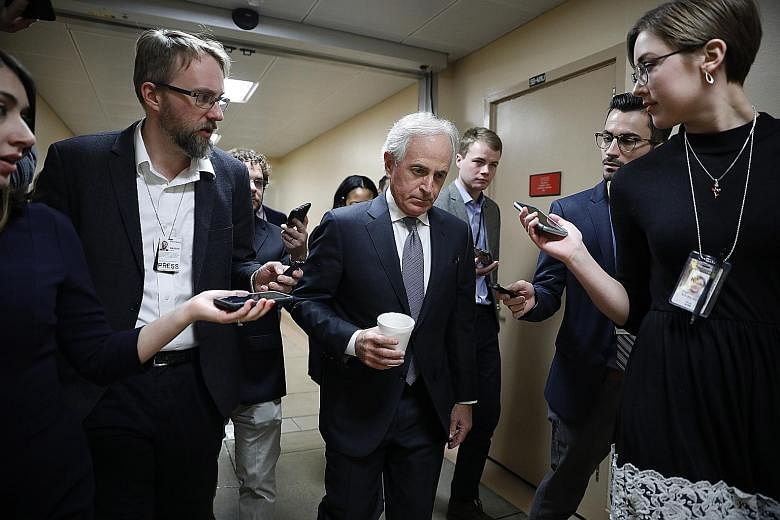 Reporters surrounding Senator Bob Corker at the US Capitol in Washington on Thursday. Mr Corker and other senators have met Trump administration officials to try to hammer out compromise legislation to tighten restrictions on Iran while keeping Washi
